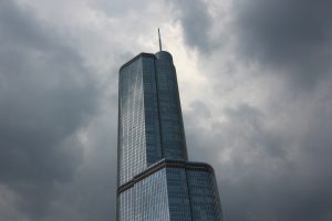 An image of a sky scraper surrounded by clouds